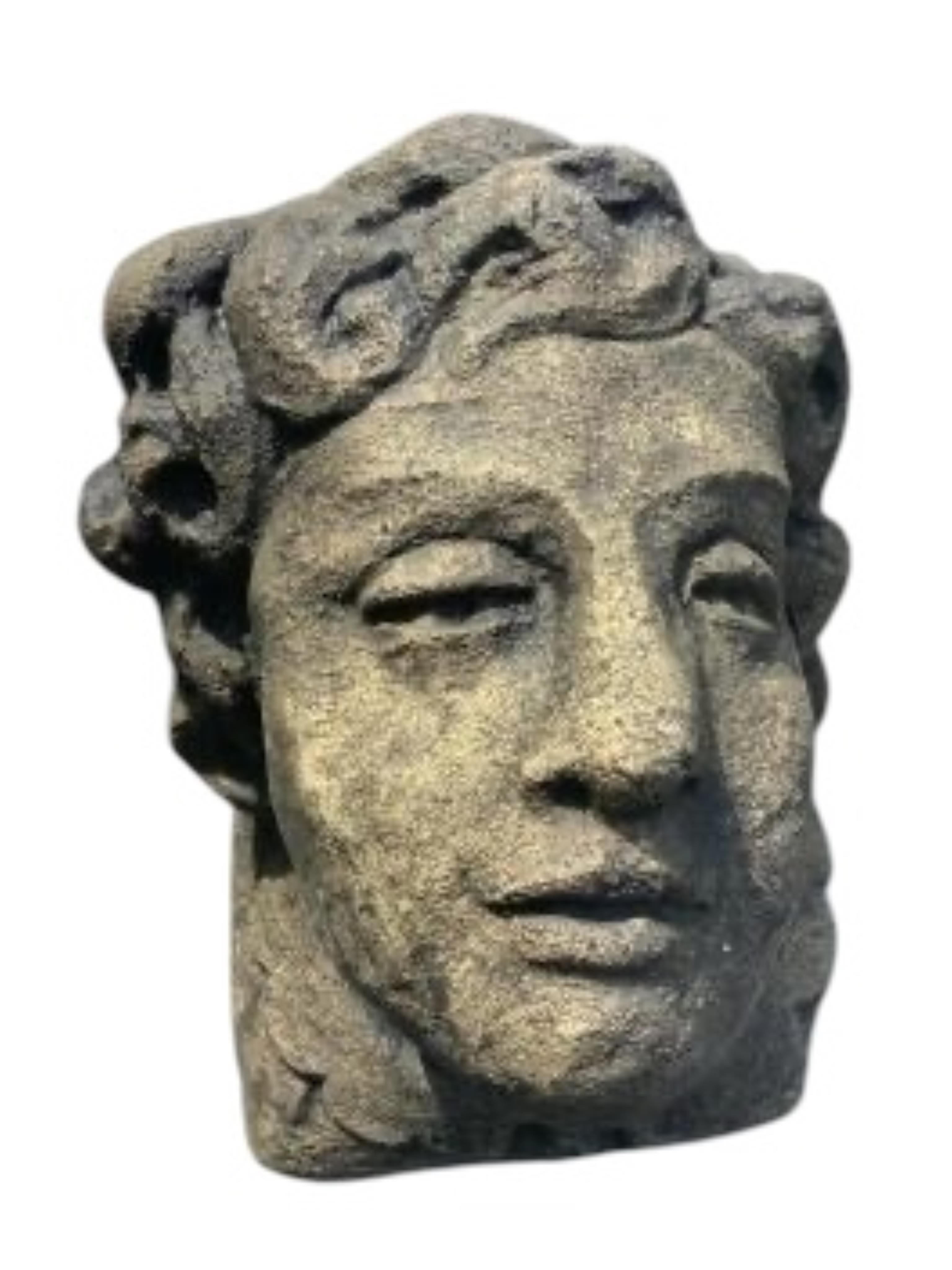 A pair of cast stone mask corbels, height 21cm